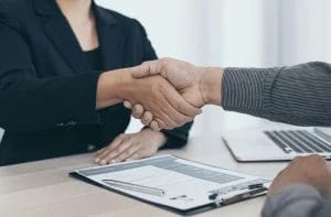 An interviewer shaking hands with an interviewee
