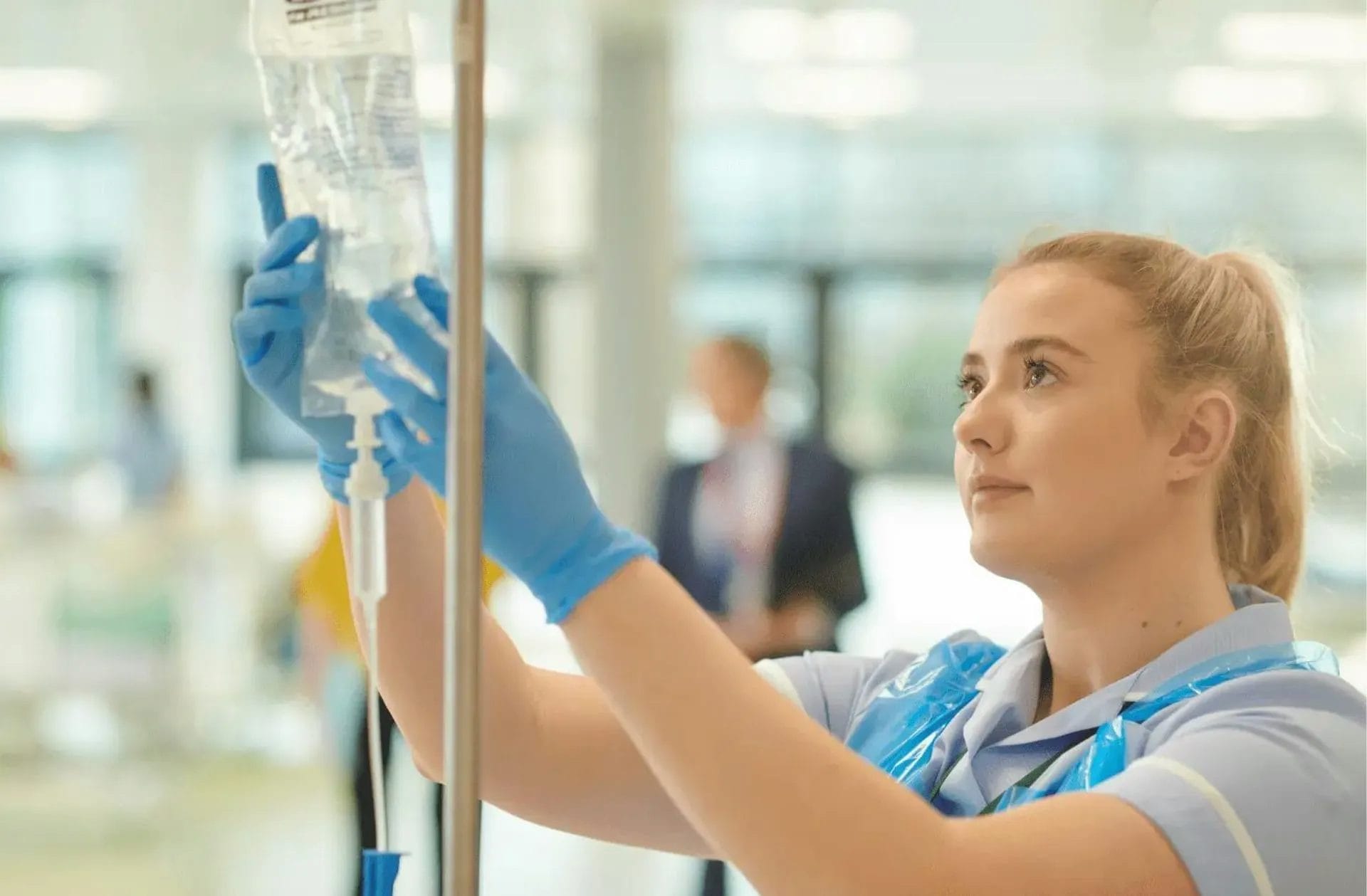 A nurse using an IV drip