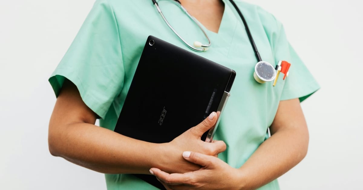 A nurse holding a laptop